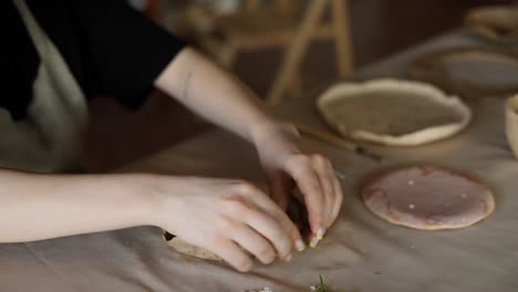 hand shaping pottery from clay