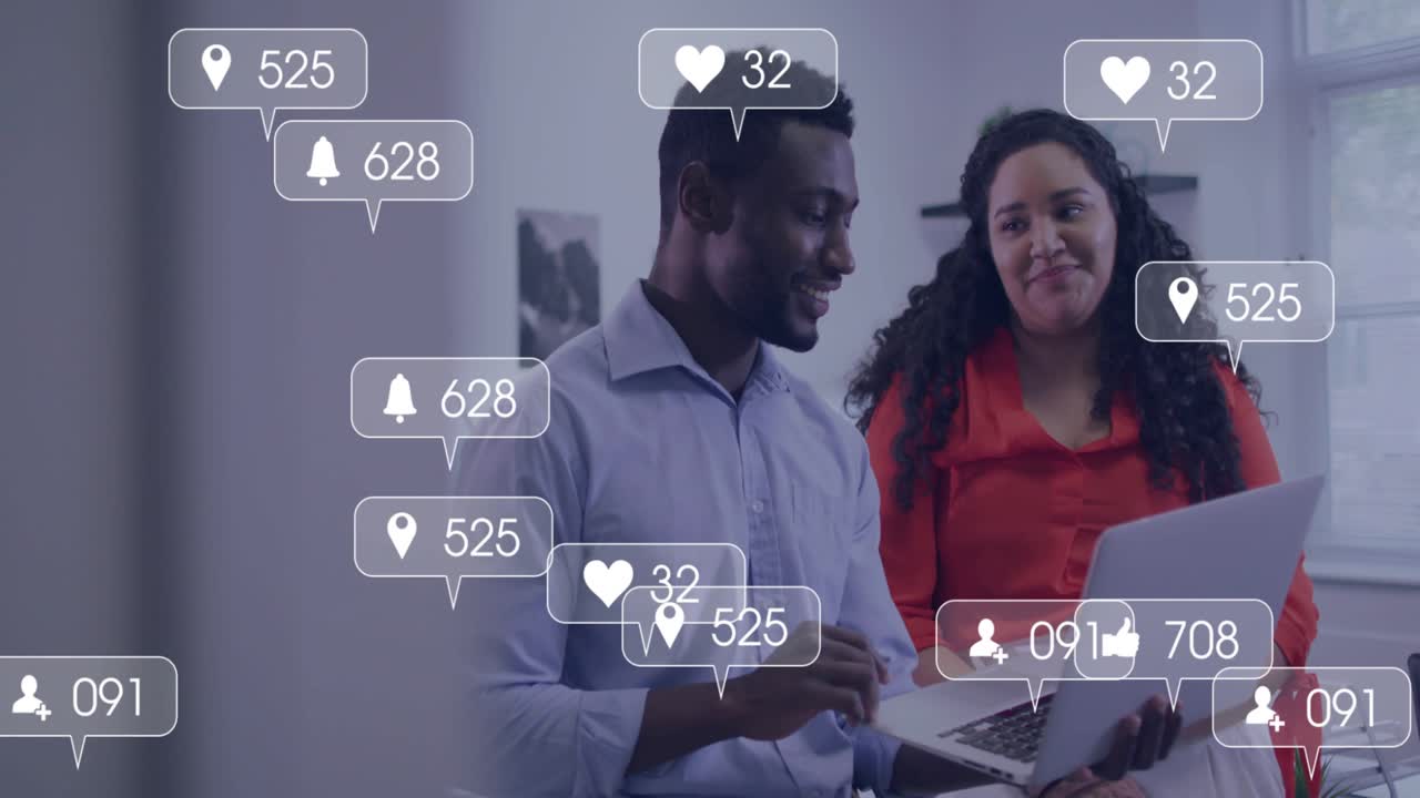 Woman and man viewing laptop, social icons piling up and showing rising marketing engagement