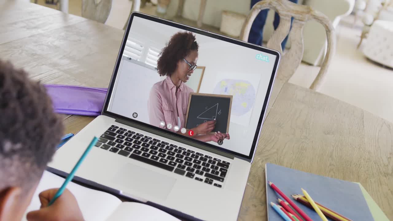 Diverse male student having class during laptop video call with female teacher in slow motion