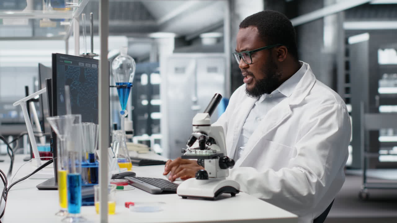 Vertical video Scientist using PC to process patient data, communicating results to coworkers