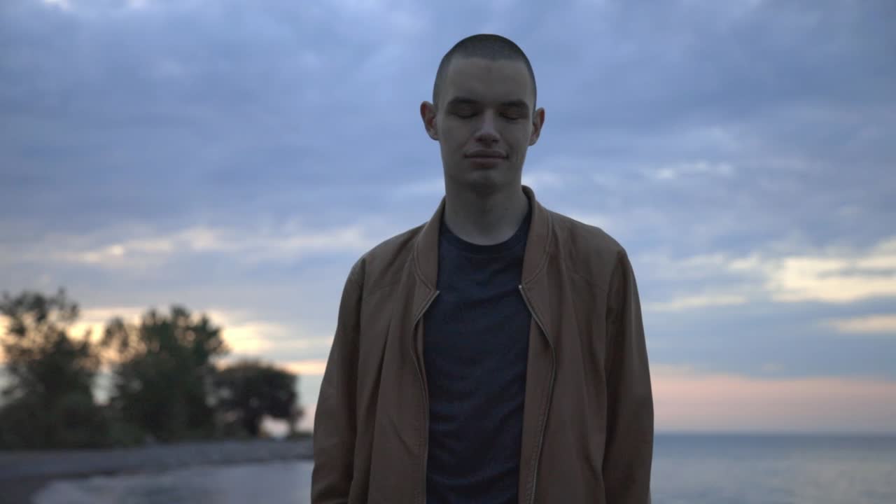 Happy Man Standing At The Shore Against The Blue Cloudy Sky Background - Half-Body Shot