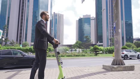 Businessman-drives-electric-scooter-on-city-street.