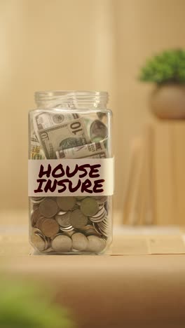 vertical video of person saving money for house insure