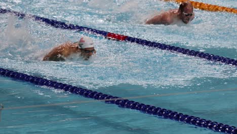 swimmers racing in a pool during a competition