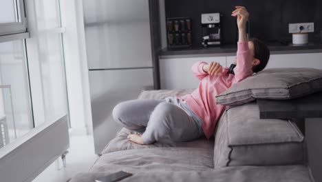 Smiling-Girl-Having-Fun-Time-At-Kitchen,-Falling-On-Sofa