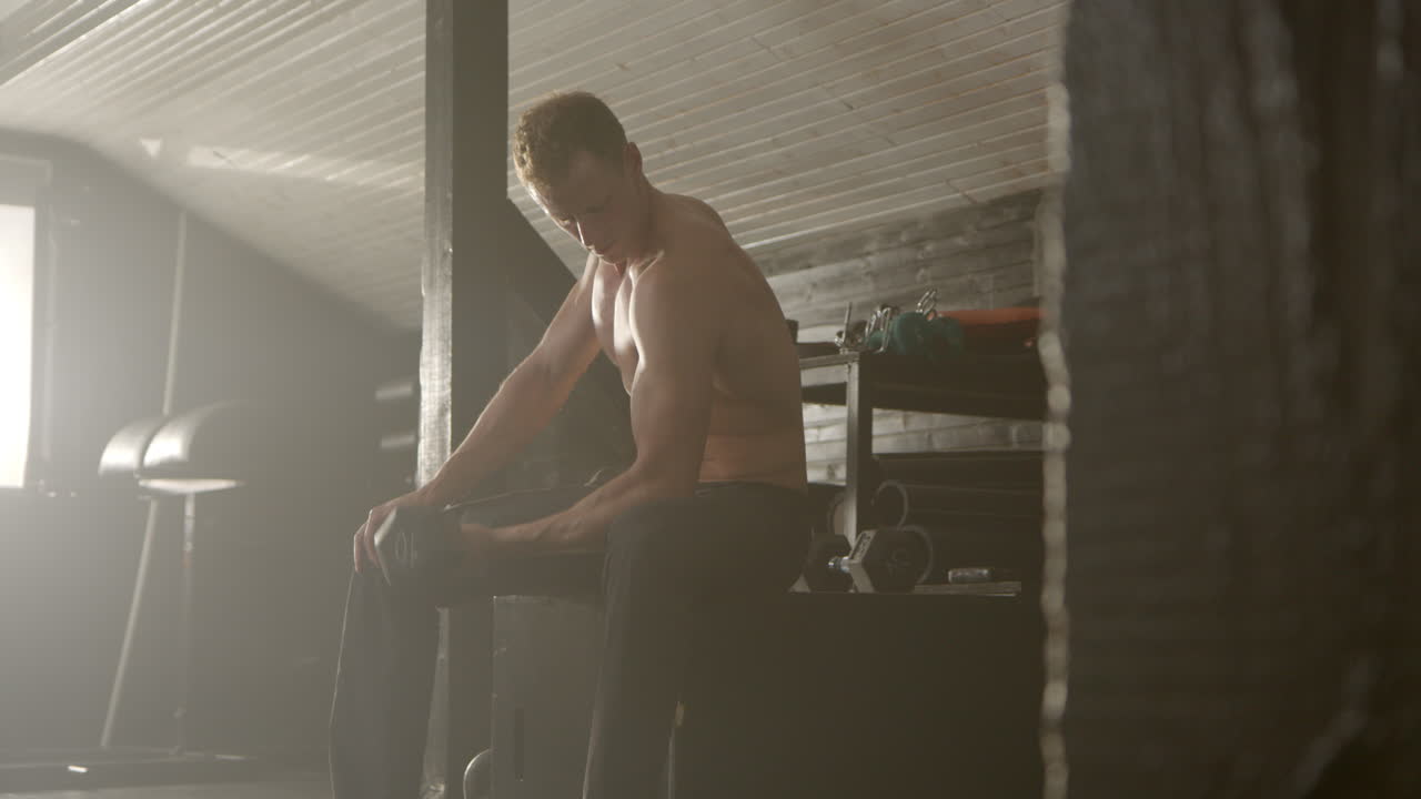 Man working out with dumbbells in a gym
