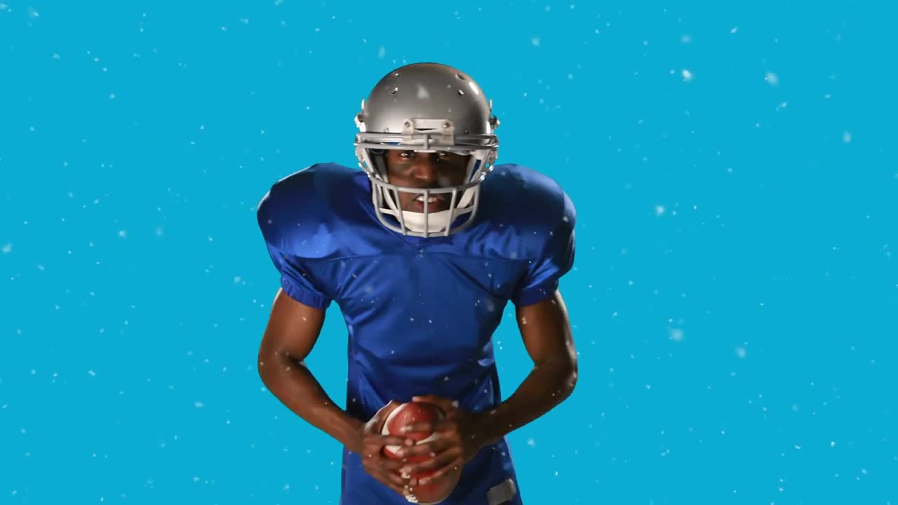 Animazione di neve che cade su un giocatore di football americano con il pallone su sfondo blu