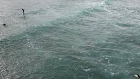 young thrill seeking adventurous man riding fast on an electric hydrofoil in clear blue ocean water, the future of green renewable water craft technology is here