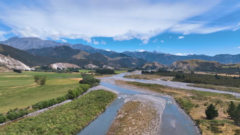 aerial flies over the channels of buller river approaching the vast landscape of new zealand's lower buller gorge towards foothills and towering mountains west coast aotearoa nz