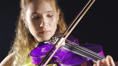 the female violinist plays the violin at the music school, the musician plays the violin at the opera.