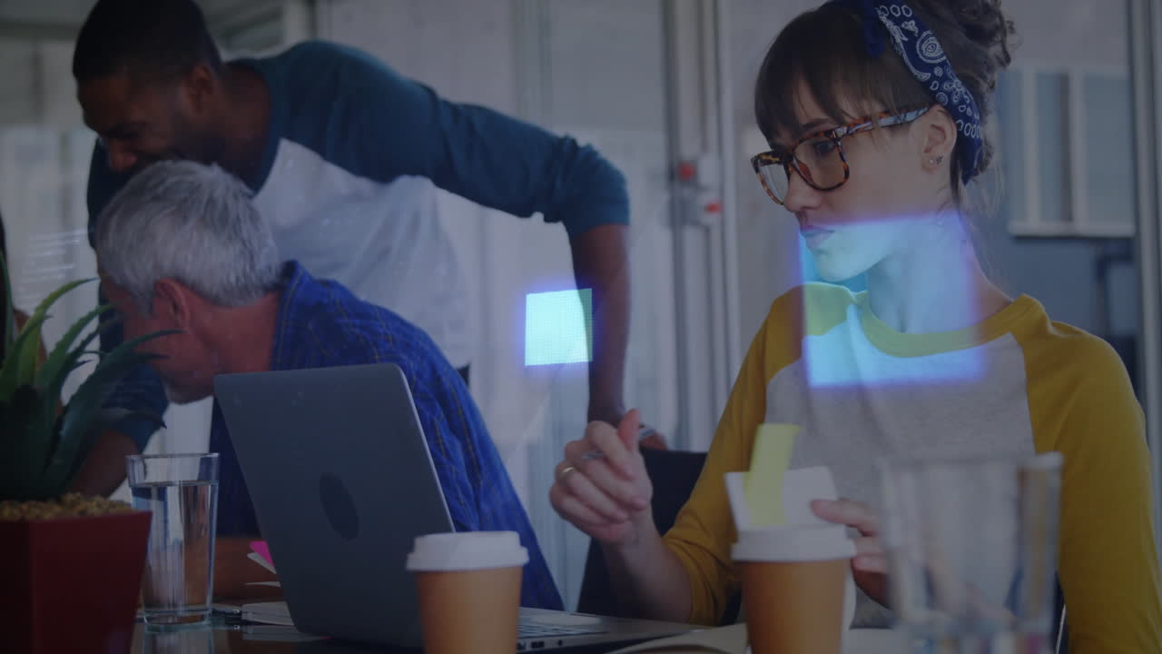 Diverse team collaborating at office with digital data overlay animation