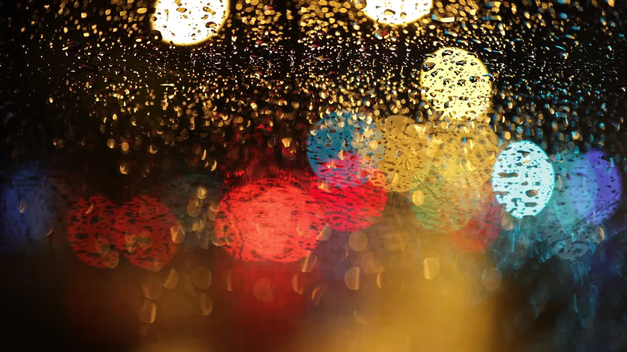 Night city traffic in the rain. Car lights through wet glass.  Abstract shot of evening city traffic bokeh