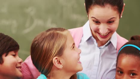 teacher and pupils looking at laptop