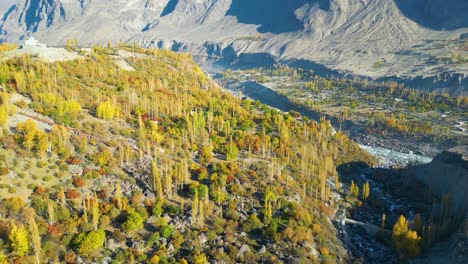 Cinematic-drone-shot-over-Skardu-Valley-with-yellow-and-green-trees-in-Autumn-weather-with-mountains