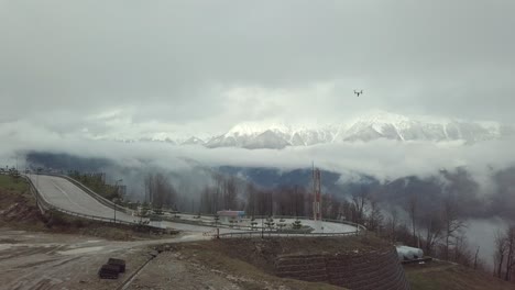 drone flight over mountain pass in cloudy weather