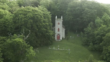 exterior view of curraclone church with graveyard in countryside of stradbally, laois, ireland