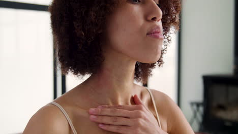 close up view of woman touching her neck