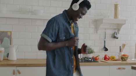 man dancing in kitchen to music