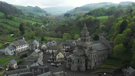 Stunning-church-with-mist-rolling-over-a-vivid-green-hills-in-a-valley