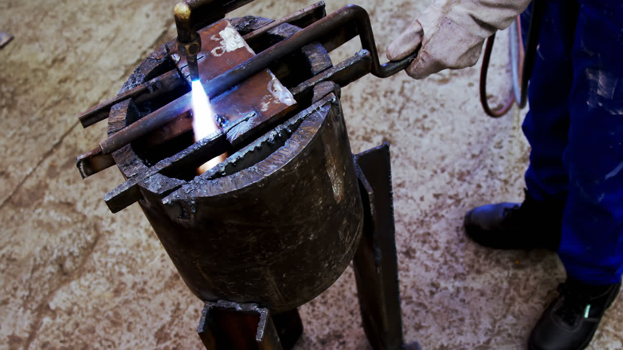 Male engineer using welding torch 4k