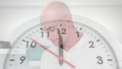 animation of clock ticking over caucasian businessman using tablet