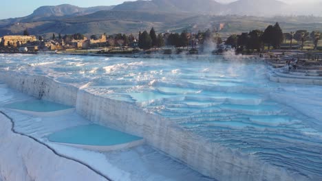 Steamy-blue-hot-springs,-mineral-waters,-forming-travertine-limestone-mineral-deposit-formations