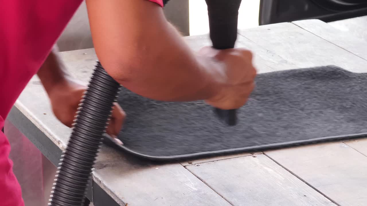 Vacuuming a Car Mat