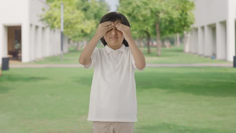 sick indian boy having a headache in park