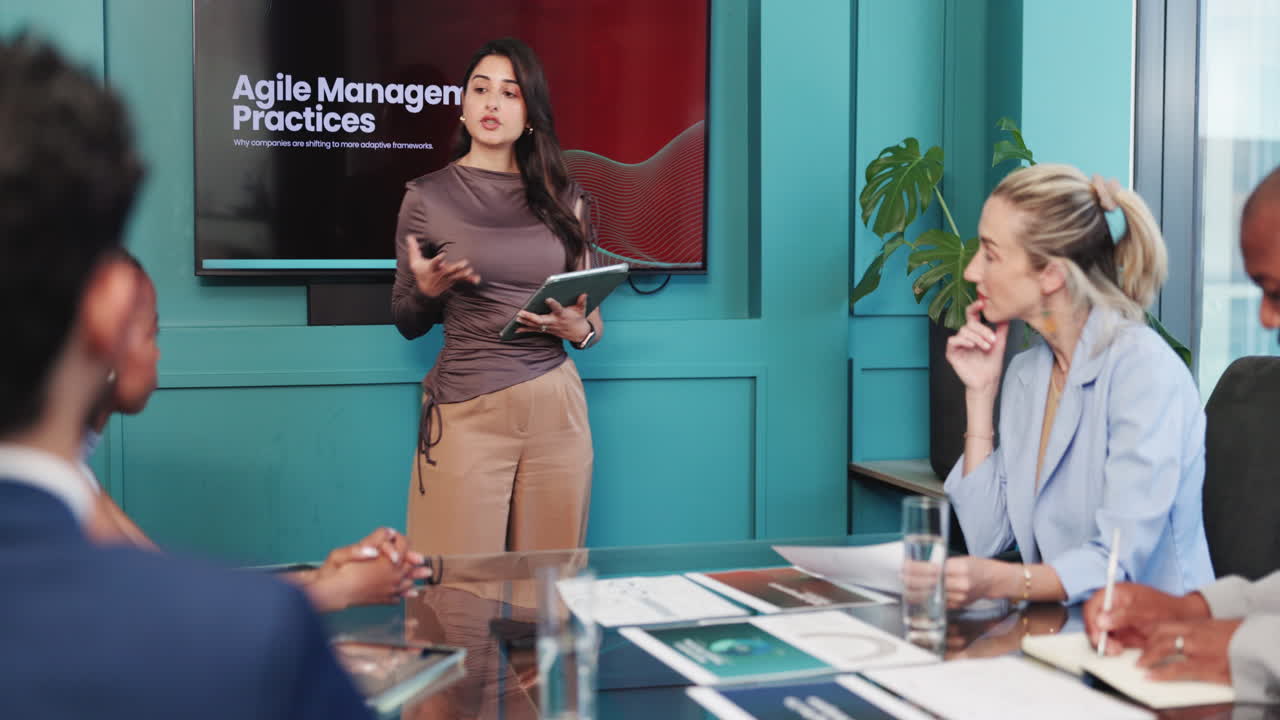 Businesswoman Giving Presentation on Agile Management Practices in Office Meeting