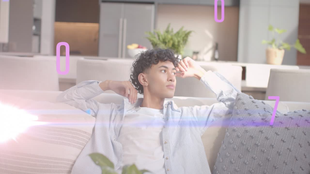 Man reclining sofa, data graphics appearing over face while tilting, touching temple, thinking tech