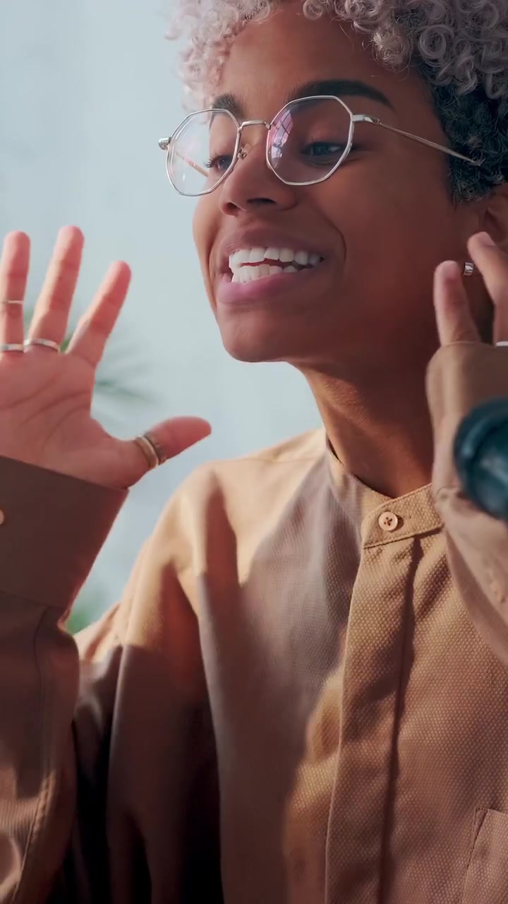 Expressive young woman uses hand gestures to emphasize her point while recording