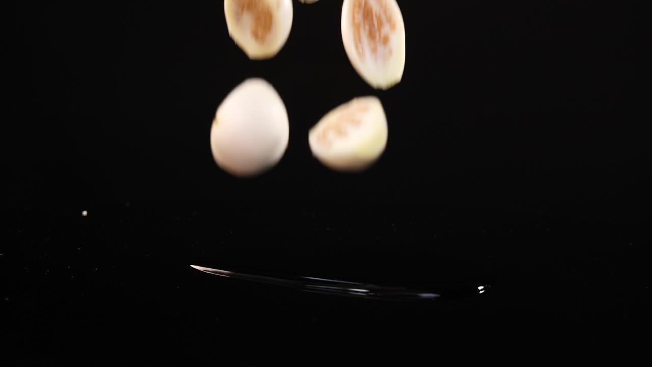 Sliced eggplants drop and scatter on surface