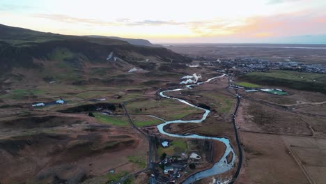 aerial view of meandering river and plateau landscape at sunset in the town of hveragerdi in south iceland