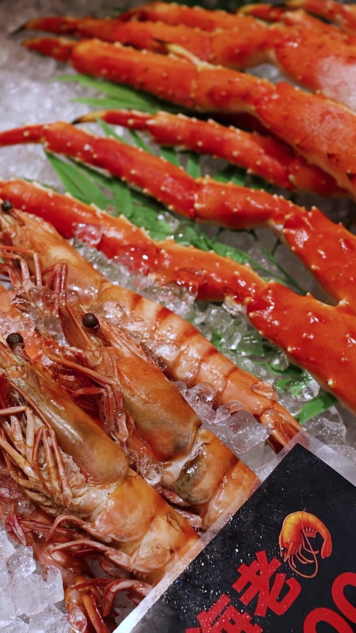 Fresh King Crab Legs and Large Shrimp on Ice at Seafood Market