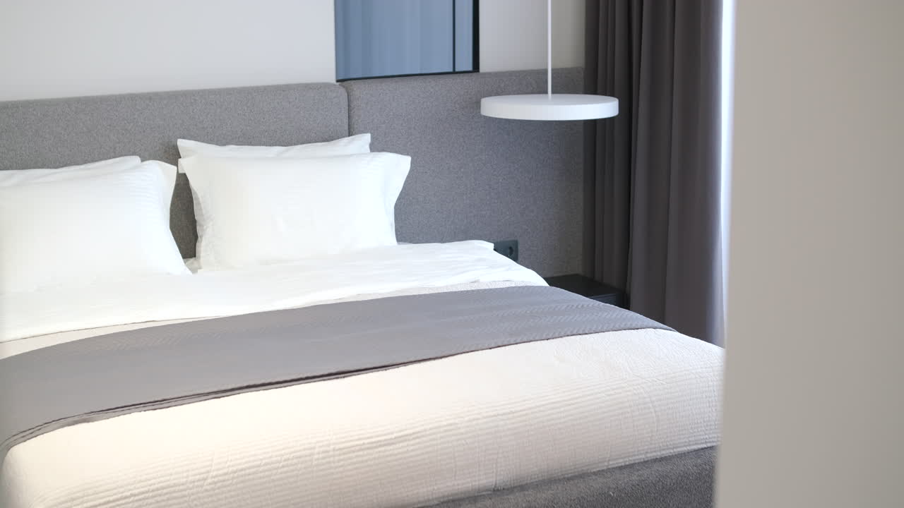 Kamar Tidur Modern dan Bersih dengan Ranjang Putih dan Aksen Abu-abu