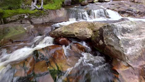 Aerial-Shot-of-Waterfall-in-Rocky-Mountains-in-Norway