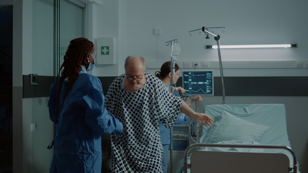 Sick patient sitting in wheelchair in hospital ward at clinic