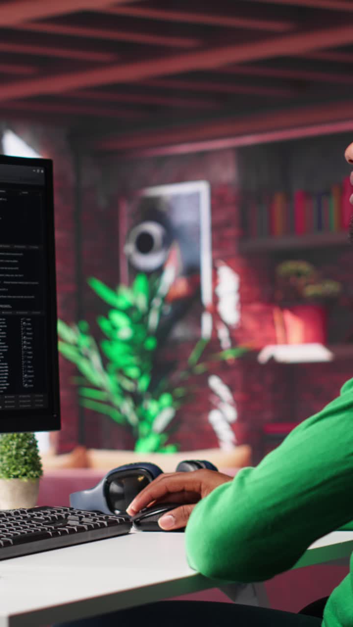 Vertical Video African american man looking at UI on PC screen at home office