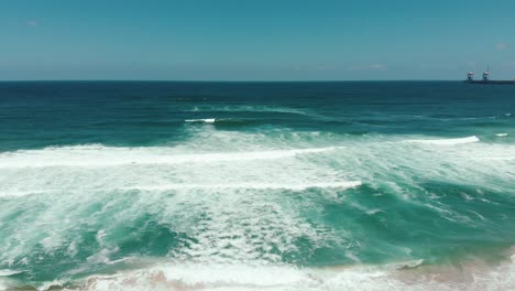 Drone-Aéreo-Moviéndose-Rápido-Mostrando-Interminables-Olas-Salvajes-Rompiendo-En-La-Costa-Arenosa