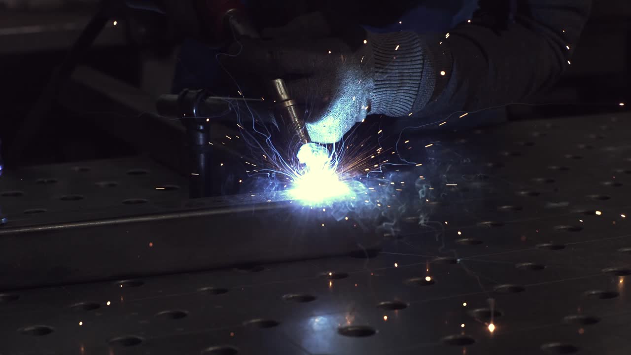 Starting Mag Welding on a steel pipe.Super Slow motion Welding shot