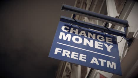 change money sign at night with rain and vignette