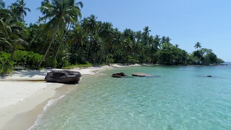 aerial, dolly zoom, drone shot flying over a paradise beach and turquoise sea, on a warm and sunny day, in koh kood, thailand, asia