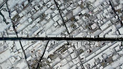 Aerial-Birds-Eye-View-Over-Snow-Covered-Skardu-City-In-Gilgit-Baltistan-With-Road-Running-Through-The-Middle