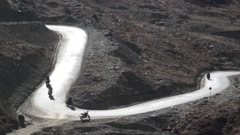 motorcycles driving on a winding mountain road