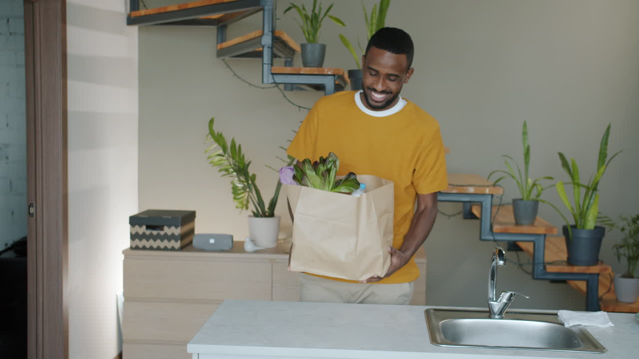 Happy Man Shopping for Groceries at Home