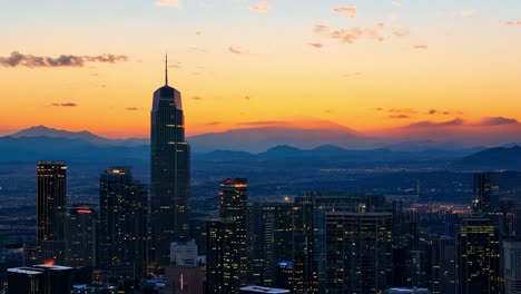 the los angeles skyline transitions from day to night, with vibrant colors illuminating the urban landscape