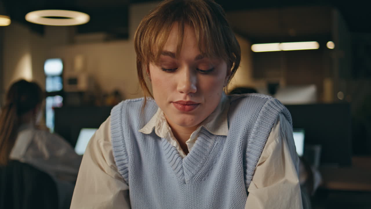 Pondering employee looking distance waiting message at dark open space closeup