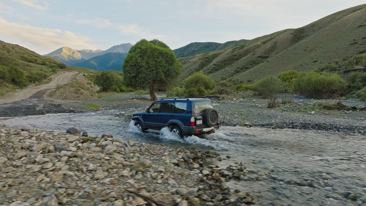 Four-wheel Drive SUV Crossing The River With Shallow Water In Kazakhstan