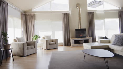 general view of modern living room with fireplace and furniture with copy space, slow motion