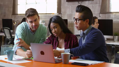 designers using laptop in modern office meeting shot on r3d